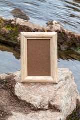 Empty Picture Frame on Rock in River
