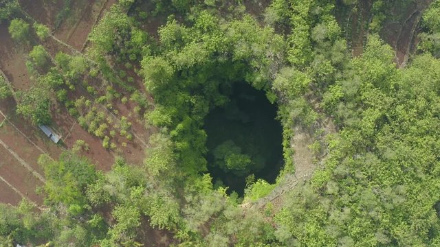 Top down drone shot view descending above the Jomblang Cave in Yogyakarta Indonesia