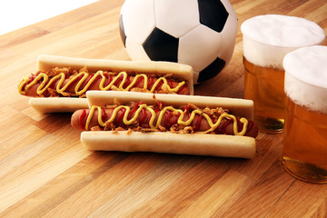 Grilled hot dogs with mustard and ketchup on the table with draft beer for football soccer party time