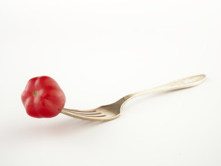 Ripe, red cherry tomatoes of the confetto variety.Isolate.White background