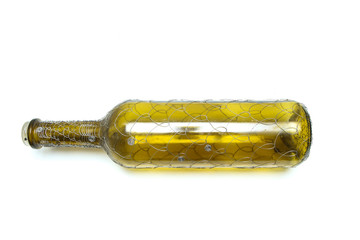 Fototapeta premium The wire brushed wine bottle. The traditional decorative craft. In a white background. 