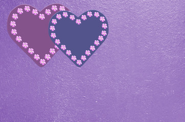 Background with hearts and flowers in purple and pink tones