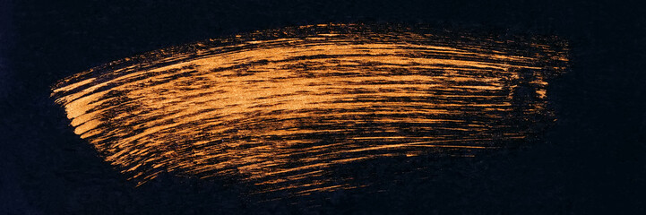 Barcode with golden paint brush on black paper.