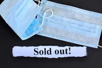Announcement with Text Sold out! on black background with respiratory protective medical masks
