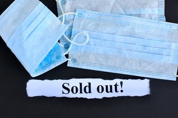 Announcement with Text Sold out! on black background with respiratory protective medical masks