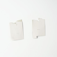 torn piece of white cardboard paper on a white background