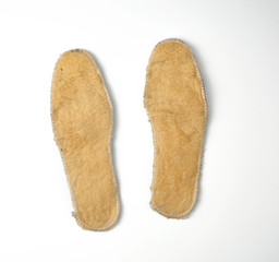 pair of shoe insoles with insulation and fleece on a white background