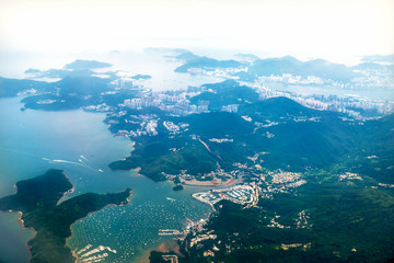 Naklejka na ściany i meble Aerial view of Hong Kong islands with harbour from a flying airplane