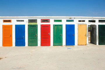 The colorful doors of one of the old changing rooms or cabins at a beach in Croatia. 
