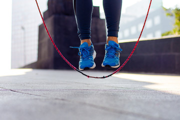 Close up of an athletic person's feet jumping rope outdoor