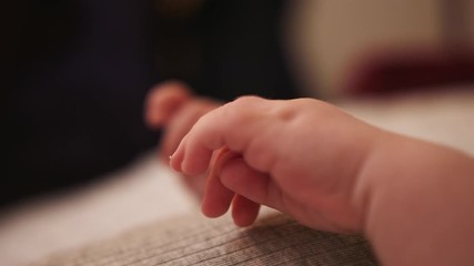 Tiny newborn baby hands extreme close up slow motion shot. Racking focus