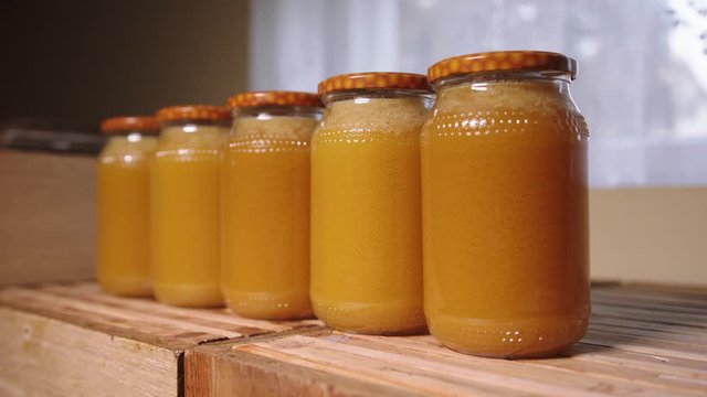 Crystalized honey in the jars, close up dolly out shot. Selective soft focus
