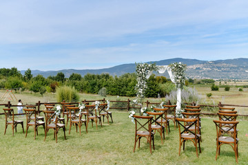 Ceremonial wedding archway and chiavari chairs  for guests outdoors
