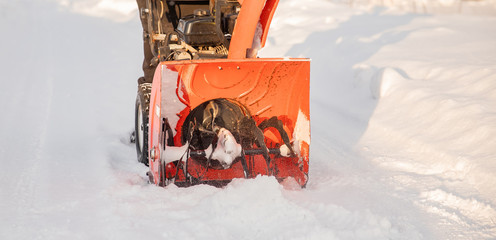 Man cleaning snow from thrower blower machine removal ice storm winter