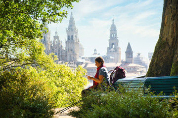 Tourist Woman On Pilgrimage At Santiago De Compostela With Phone - obrazy, fototapety, plakaty
