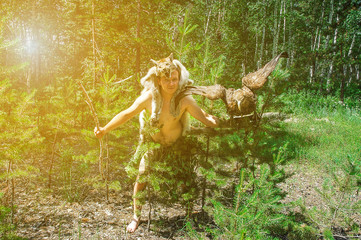 primitive man in the forest hunting with sitting on the arm of an eagle and a lynx skin