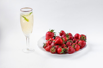 two glasses of champagne and a plate of strawberries
