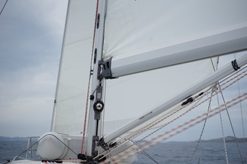 Detail of a moving sailboat with main mast and rigging