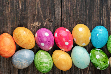 Different easter eggs on wooden background