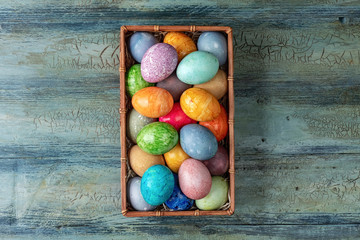 Easter eggs in a box on wooden background