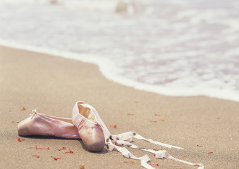 Fototapeta na wymiar ballet shoes on beach