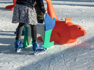 SAINT TROPEZ, FRANCE - DECEMBER 31, 2019: A girl ice skater with her toys on the ice rink in Saint Tropez.