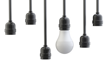 Naklejka premium Light bulb in electric cartridge on wires, the other cartridges are empty. Leadership concept