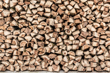 texture woodpile with dry firewood, close-up abstraction background