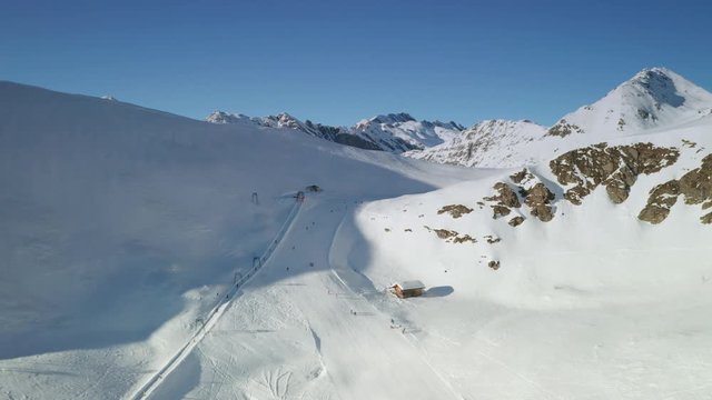 Aerial 4k winter footage of snow covered mountains. Winter sport region. Pistes and lifts in the Gitschberg Jochtal skiing region, South Tyrol. Reveal shot of the mountain range.