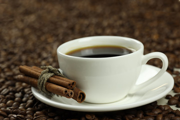 coffee cup, cinnamon sticks and coffee beans