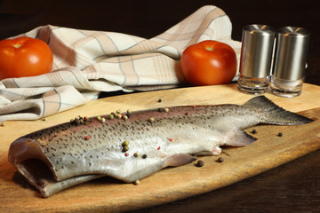 fresh uncooked fish on a cutting board