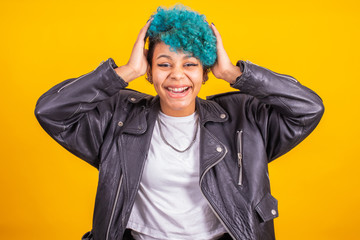 afro american girl with blue curly hair isolated on yellow background