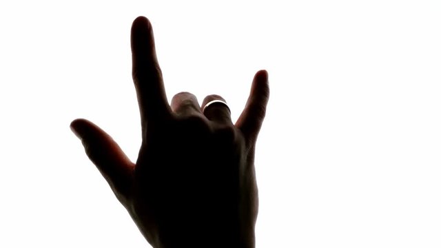 Rock and roll music devil horns hand sign on a chroma key white screen 