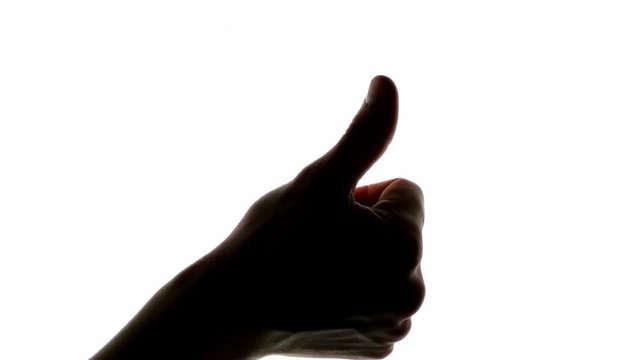 Thumbs up ok hand sign on a white chroma key screen, closeup 