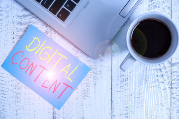 Conceptual hand writing showing Digital Content. Concept meaning any content that exists in the form of digital data Metallic laptop blank sticky note coffee cup lying vintage table