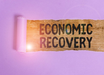 Handwriting text Economic Recovery. Conceptual photo rise of business activity signaling the end of...