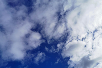 Sunny day, bright blue sky with various forms of clouds background for design, decoration or wallpaper