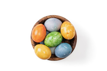 Different easter eggs in ceramic bowl isolated on white