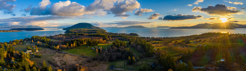 Aerial Panoramic View of Lummi island During a Glorious Sunset. Located in the Salish Sea, Orcas Island can be seen on the right with Bellingham Bay on the left.  - 320904167
