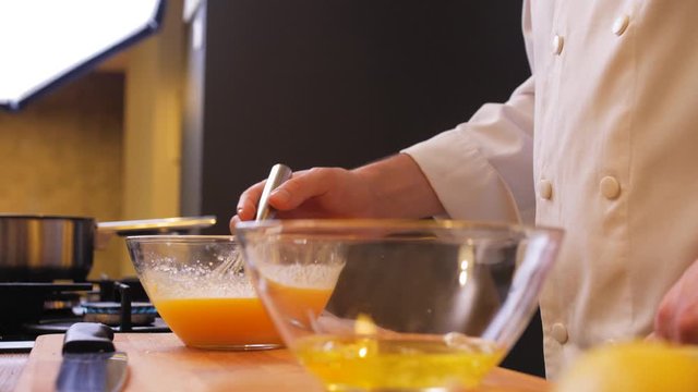 the chef checks the consistency of the dough in a bowl