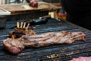 Delicious piece of meat, striploin on a charcoal barbeque.