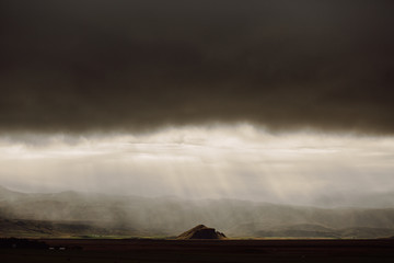 lonely mountain with dramatic clouds in Iceland