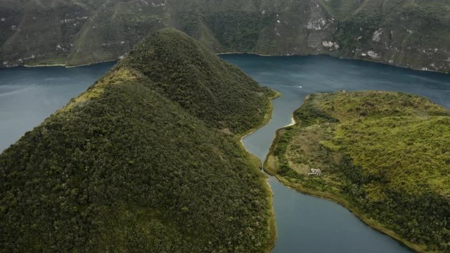 Aerial flies sidewards showing the beautiful Islands of Cuicocha, Otavalo Ecuador.