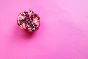 Pomegranate isolated on pink background. Top view.