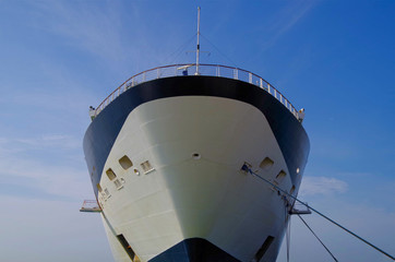 Detail view of bow and superstructure of modern cruiseship or cruise ship liner against blue sky
