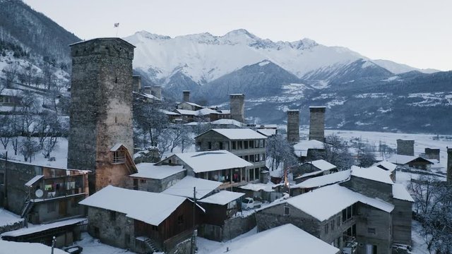Aerial drone camera footage of Mestia village in Svaneti region, Georgia, Caucasus. In the shot you can see famous Svan defensive towers typical for that region. Shot in winter time.
