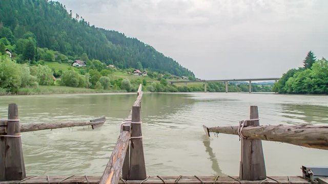 Slow motion of man rowing on a timber rafting wharf at a Slovenian event in Drava River