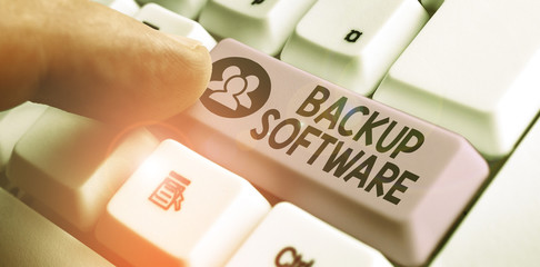 Writing note showing Backup Software. Business concept for create extra exact copies of files or...