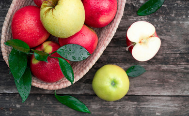 apples in a basket on a wooden background