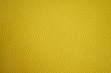 Leather texture close up. Yellow fashionable background, top view. Stylish wallpaper of golden...